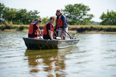 Students in a boat at the Aquacultural Research