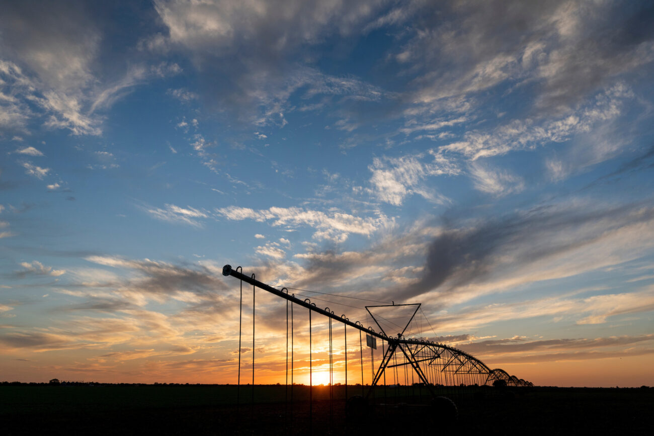 Irrigation system in field at sunset
