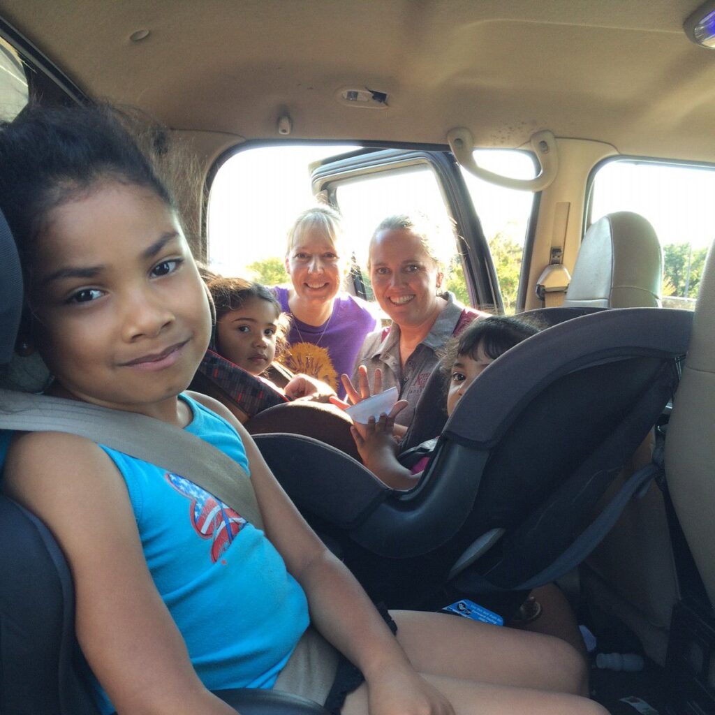 Women with 3 children in carseats