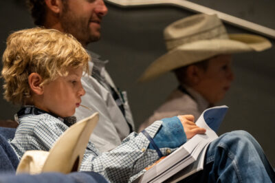 child listening to a speaker at the Beef Cattle Short Course