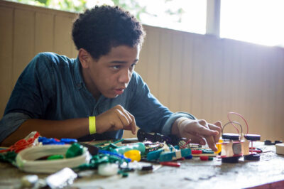teen working with robotics equipment