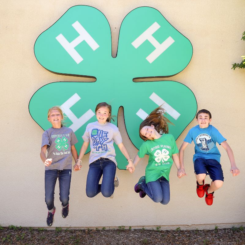 four kids jumping in the air