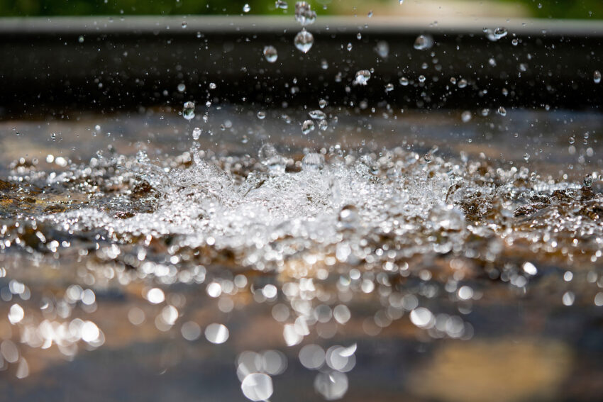 water splashing into a pond