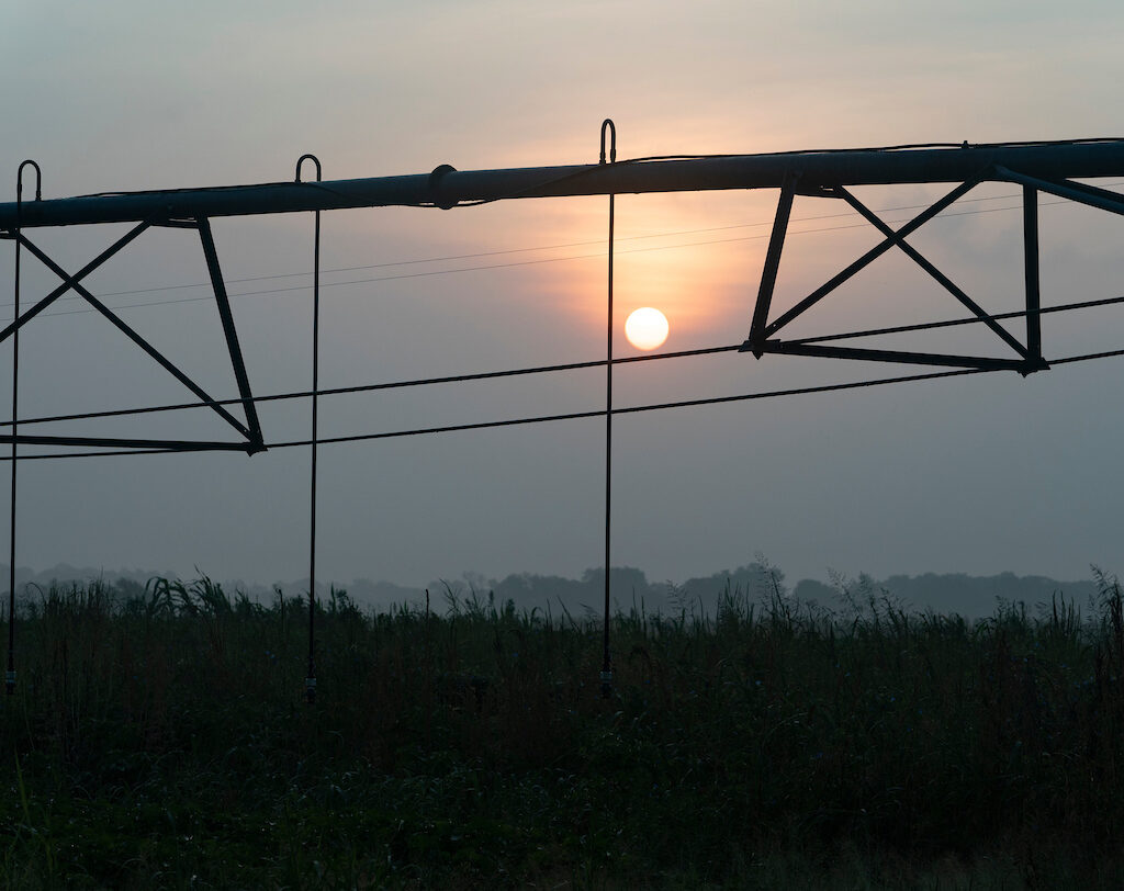 Irrigation pivot with sunset in the background