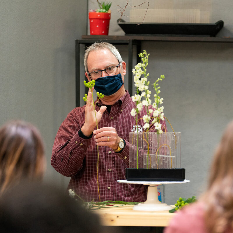 teacher demonstrating a technique during a floral arts class