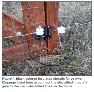 Figure 4. Black-colored insulated electric fence wire, 12-gauge. Used here to connect the electrified lines of a gate to the main electrified lines on the fence.